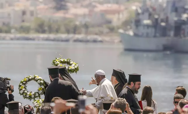 FILE - Pope Francis, center, Ecumenical Patriarch Bartholomew I, left, and Archbishop of Athens Ieronymos II, toss floral wreaths into the sea on the Greek island of Lesbos, April 16, 2016. (AP Photo/Petros Giannakouris, File)