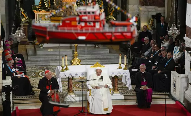 FILE— A model boat hangs from the ceiling of the Notre Dame de la Garde Basilica as Pope Francis delivers a speech in Marseille, France, Sept. 22, 2023. (AP Photo/Daniel Cole, File)