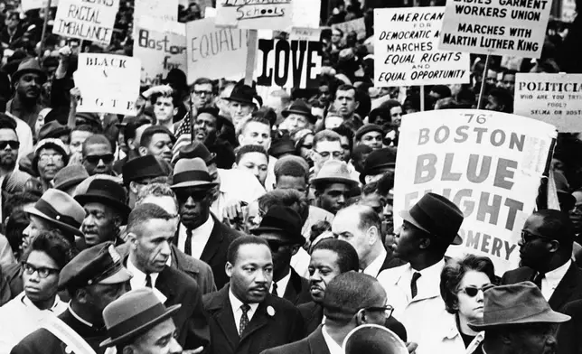 Dr. Martin Luther King Jr., is completely surrounded as he leads a civil rights march in Boston, April 23, 1965, en route to historic Boston Common where he will address a crowd. (AP Photo, file)
