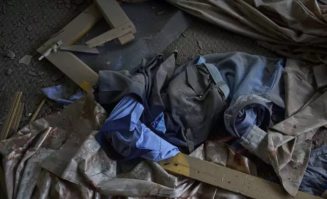 The school uniform lies scattered in a neighbouring house is seen after Indian forces blew up the family home of Ahsan Ul Haq Shiekh, a militant who officials say is involved in the deadly attack on tourists in Pahalgam, at Murran village in Pulwama, south of Srinagar, Indian controlled Kashmir, Saturday, April 26, 2025. (AP Photo/Dar Yasin)