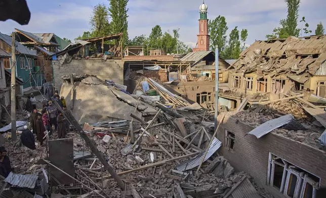 Kashmiri villagers inspect the debris of the blown-up family home of Ahsan Ul Haq Shiekh, a militant who officials say is involved in the deadly attack on tourists in Pahalgam, at Murran village in Pulwama, south of Srinagar, Indian controlled Kashmir, Saturday, April 26, 2025. (AP Photo/Dar Yasin)