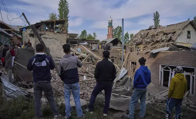 Kashmiri villagers inspect the debris of the blown-up family home of Ahsan Ul Haq Shiekh, a militant who officials say is involved in the deadly attack on tourists in Pahalgam, at Murran village in Pulwama, south of Srinagar, Indian controlled Kashmir, Saturday, April 26, 2025. (AP Photo/Dar Yasin)