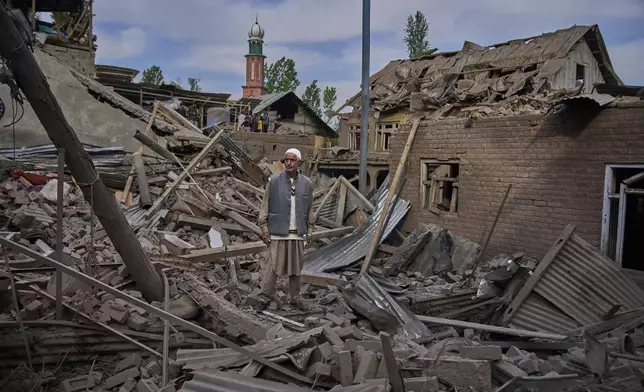 A Kashmiri villager stands amid the debris of the blown-up family home of Ahsan Ul Haq Shiekh, a militant who officials say is involved in the deadly attack on tourists in Pahalgam, at Murran village in Pulwama, south of Srinagar, Indian controlled Kashmir, Saturday, April 26, 2025. (AP Photo/Dar Yasin)