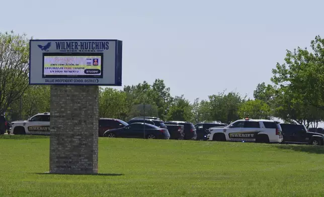 Sheriff vehicles sit parked in a lot at Wilmer-Hutchins High School, where police are responding to reports of a shooting in Dallas, Tx., Tuesday, April 15, 2025. (AP Photo/Julio Cortez)