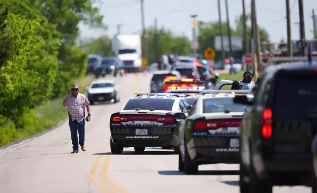 An undercover Texas Highway patrolman arrives to Wilmer-Hutchins High School, where police are responding to reports of a shooting in Dallas, Tx., Tuesday, April 15, 2025. (AP Photo/Julio Cortez)