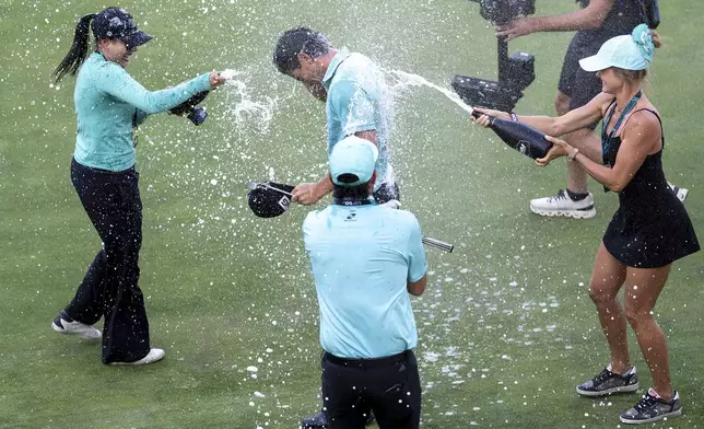 First-place individual champion captain Joaquín Niemann, center top, of Torque GC, is sprayed on the 18th green after the final round of LIV Golf Mexico City at Club de Golf Chapultepec, Sunday, April 27, 2025, in Naucalpan, Mexico. (Mateo Villalba/LIV Golf via AP)