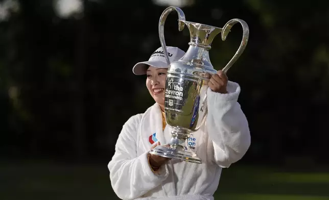 Mao Saigo, of Japan, holds the trophy after winning the Chevron Championship LPGA golf tournament Sunday, April 27, 2025, in The Woodlands, Texas. (AP Photo/Ashley Landis)