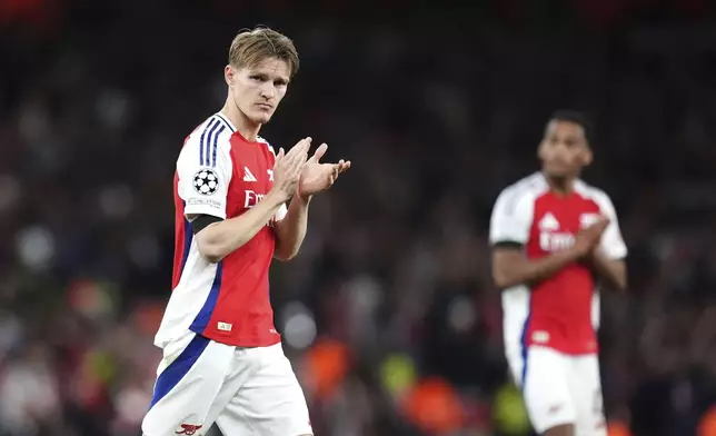 Arsenal's Martin Odegaard applauds the fans following the Champions League semifinal first leg soccer match between Arsenal and Paris Saint-Germain at Emirates Stadium in London, England, Tuesday, April 29, 2025. (Adam Davy/PA via AP)