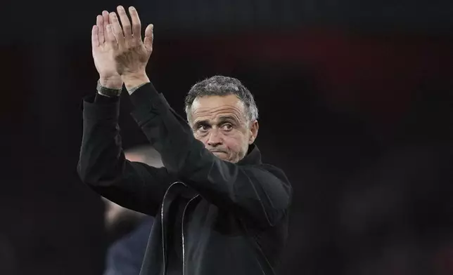 PSG's head coach Luis Enrique applauds the fans at the end of the Champions League semifinal first leg soccer match between Arsenal and Paris Saint-Germain at Arsenal Stadium in London, England, Tuesday, April 29, 2025. (AP Photo/Kin Cheung)