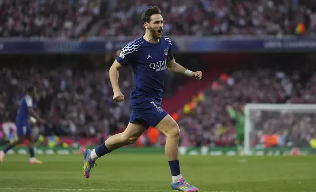 PSG's Khvicha Kvaratskhelia celebrates after his teammate Ousmane Dembele scoring his side's opening goal during the Champions League semifinal first leg soccer match between Arsenal and Paris Saint-Germain at Emirates Stadium in London, England, Tuesday, April 29, 2025. (AP Photo/Kirsty Wigglesworth)