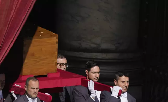 The coffin of Pope Francis is carried out of St Peter's Basilica during his funeral, in St. Peter's Square at the Vatican, Saturday, April 26, 2025. (AP Photo/Gregorio Borgia)