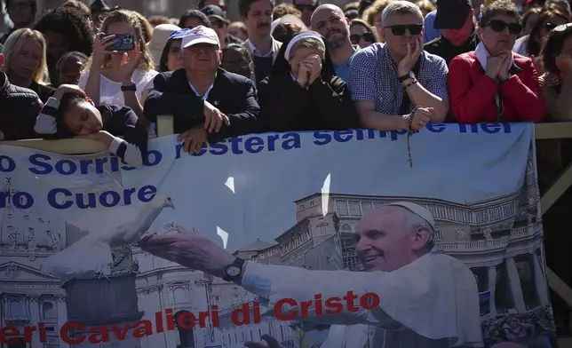Faithful listen to mass during the funeral of Pope Francis in St. Peter's Square at the Vatican, Saturday, April 26, 2025. (AP Photo/Emilio Morenatti)