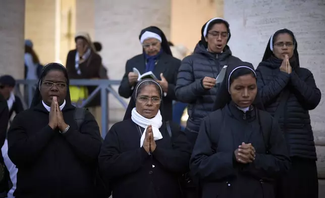 Nuns pray during the funeral of Pope Francis in St. Peter's Square at the Vatican, Saturday, April 26, 2025. (AP Photo/Emilio Morenatti)