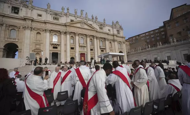 Priests take their seats ahead of the funeral of Pope Francis in St. Peter's Square at the Vatican, Saturday, April 26, 2025. (AP Photo/Alessandra Tarantino)