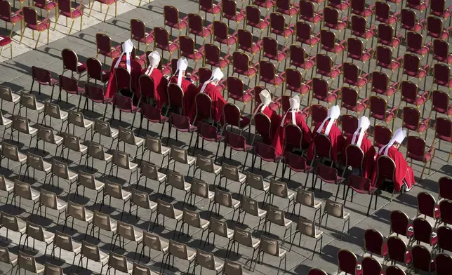 Cardinals sit in their seats ahead of the funeral of Pope Francis in St. Peter's Square at the Vatican, Saturday, April 26, 2025. (AP Photo/Markus Schreiber)