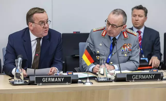 Germany's Defense Minister Boris Pistorius, left, talks as he sits next to German Inspector General of the Armed Forces Carsten Breuer during a meeting of the Ukraine Defence Contact Group at NATO headquarters in Brussels, Friday, April 11, 2025. (AP Photo/Geert Vanden Wijngaert)