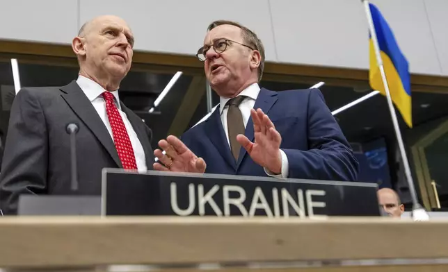 Britain's Defense Secretary John Healey, left, talks with Germany's Defense Minister Boris Pistorius during a meeting of the Ukraine Defense Contact Group at NATO headquarters in Brussels, Friday, April 11, 2025. (AP Photo/Geert Vanden Wijngaert)