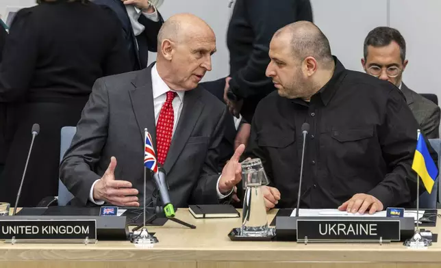 Britain's Defense Secretary John Healey, left, talks with Ukraine's Defense Minister Rustem Umerov during a meeting of the Ukraine Defence Contact Group at NATO headquarters in Brussels, Friday, April 11, 2025. (AP Photo/Geert Vanden Wijngaert)