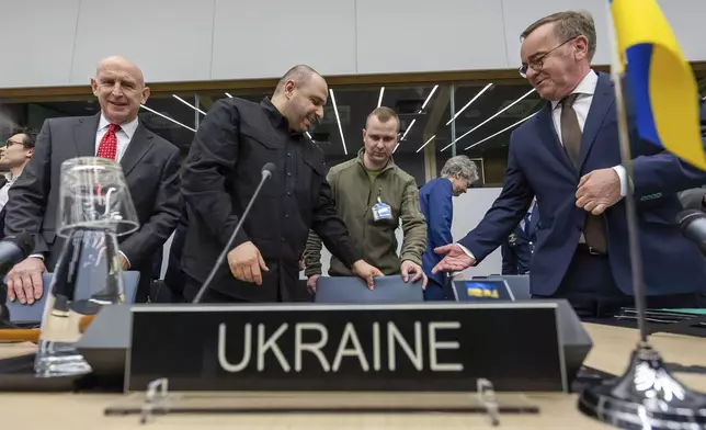 Britain's Defense Secretary John Healey, left, Ukraine's Defense Minister Rustem Umerov, second from left, and Germany's Defense Minister Boris Pistorius, right, arrive for a meeting of the Ukraine Defence Contact Group at NATO headquarters in Brussels, Friday, April 11, 2025. (AP Photo/Geert Vanden Wijngaert)