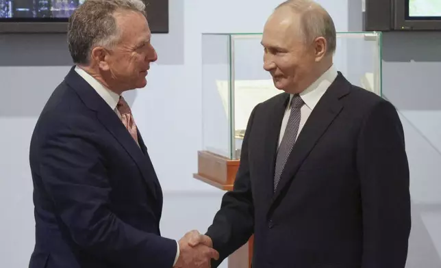 Russian President Vladimir Putin, right, and U.S. President Donald Trump's special envoy Steve Witkoff greet each other prior to their talks in St. Petersburg, Russia, Friday, April 11, 2025. (Gavriil Grigorov, Sputnik, Kremlin Pool Photo via AP)