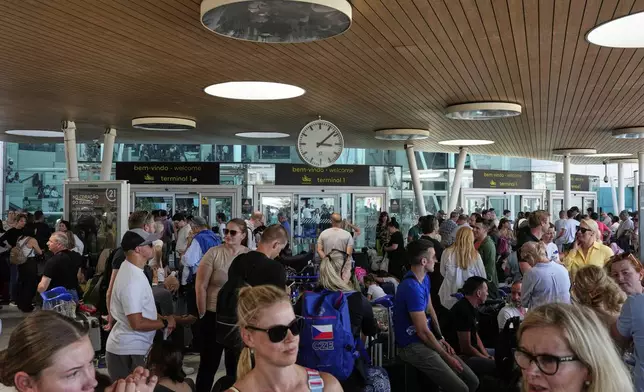 Passengers wait outside Lisbon Airport during a nationwide power outage in Lisbon, Monday, April 28, 2025. (AP Photo/Armando Franca)