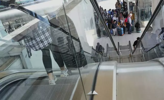 Passengers inside Lisbon Airport during a nationwide power outage in Lisbon, Monday, April 28, 2025. (AP Photo/Armando Franca)