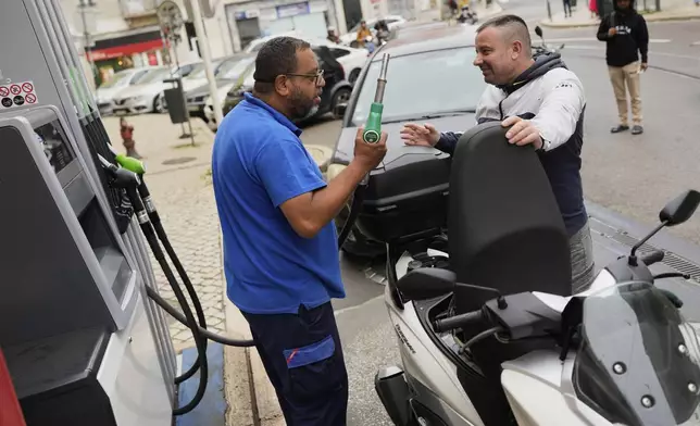 People queue for petrol in Lisbon, Tuesday, April 29, 2025, the day after a nationwide power outage that shut down gas stations, trains and subways. (AP Photo/Armando Franca)