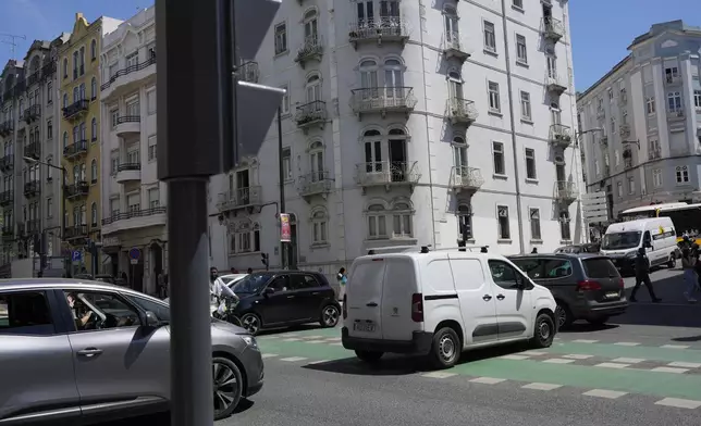 Motorists drive past traffic lights that stopped working following a power outage in downtown Lisbon, Portugal, Monday, April 28, 2025. (AP Photo/Armando Franca)