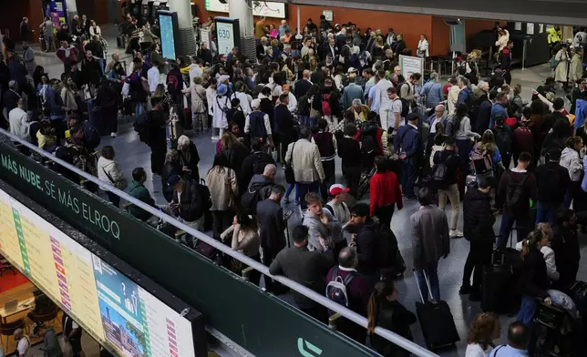 Passengers inside Atocha train station the day after a major power outage in Madrid, Tuesday, April 29, 2025. (AP Photo/Manu Fernandez)