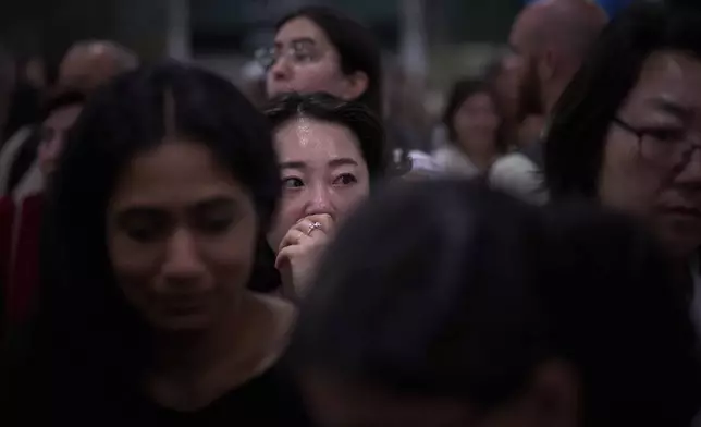 Passengers react as they wait for news of train departures, at Sants train station in Barcelona, Spain, Tuesday, April 29, 2025. (AP Photo/Emilio Morenatti)