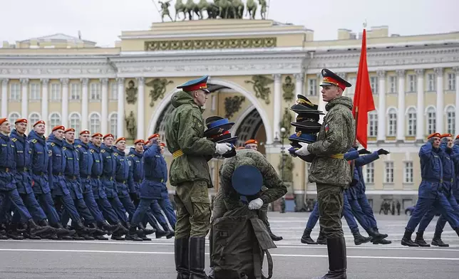 Honour guard soldiers pack caps after a rehearsal for the Victory Day military parade, which will take place at Dvortsovaya (Palace) Square on May 9 to celebrate 80 years after the victory in World War II, in St. Petersburg, Russia, Tuesday, April 22, 2025. (AP Photo/Dmitri Lovetsky)