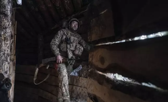 In this photo provided by Ukraine's 93rd Kholodnyi Yar Separate Mechanized Brigade press service, a soldier looks out of a shelter on the anti-drone firing position in Kostyantynivka, the site of the heavy battles with the Russian troops in the Donetsk region, Ukraine, Thursday, April 24, 2025. (Iryna Rybakova/Ukraine's 93rd Mechanized Brigade via AP).