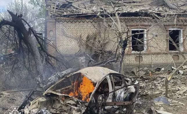 In this photo provided by the Ukrainian Emergency Service, a car burns against the background of a damaged private house following Russia's air raid in the Donetsk region, Ukraine, Monday, April 28, 2025. (Ukrainian Emergency Service via AP)