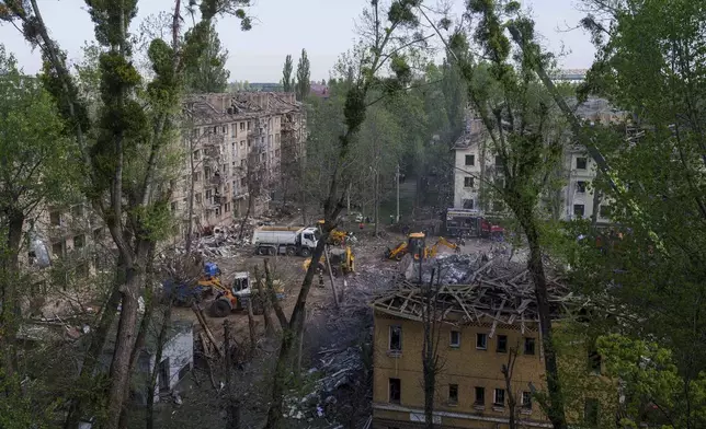 Rescue workers clear the rubble of a house destroyed by a Russian strike on a residential neighbourhood in Kyiv, Ukraine, on Thursday, April 24, 2025. (AP Photo/Evgeniy Maloletka)