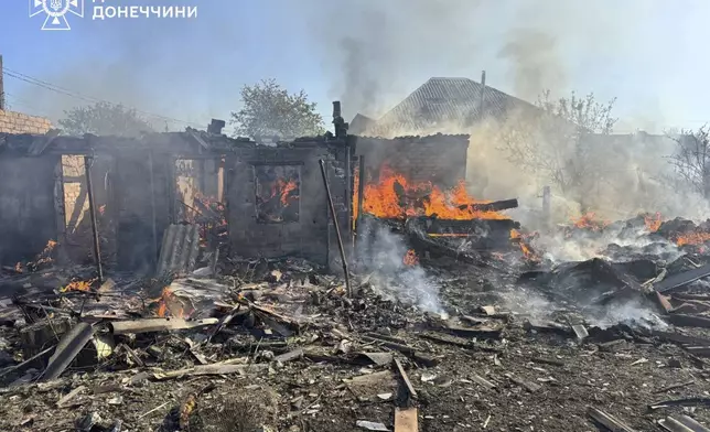 In this photo provided by the Ukrainian Emergency Service, damaged private houses burn following Russia's air raid in the Donetsk region, Ukraine, Monday, April 28, 2025. (Ukrainian Emergency Service via AP)