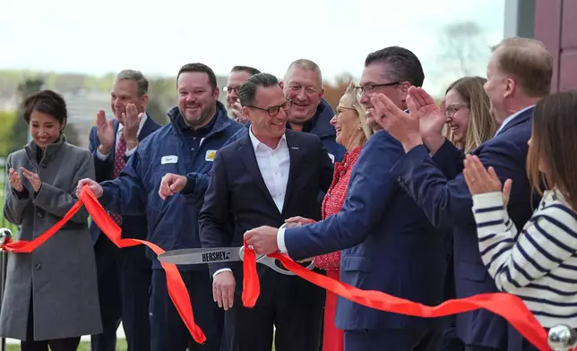 Pennsylvania Gov. Josh Shapiro takes part in a ribbon cutting ceremony the Hershey Company's new manufacturing plant in Hershey, Pa., Wednesday, April 16, 2025. (AP Photo/Matt Rourke)