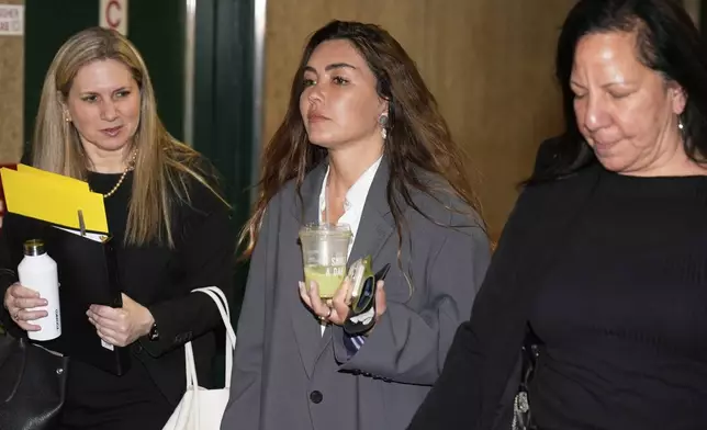 Miriam Haley, center, an accuser testifying at Harvey Weinstein's rape trial, arrives to the courtroom after a break in New York, Tuesday, April 29, 2025. (AP Photo/Seth Wenig)