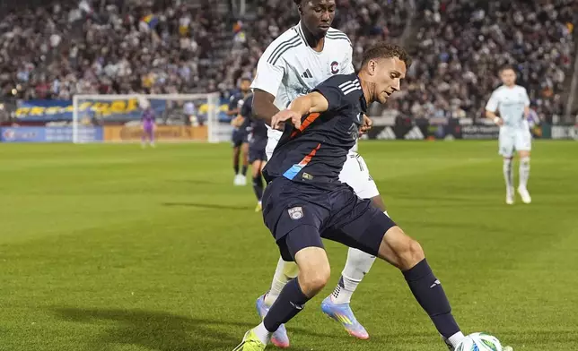 San Diego FC defender Christopher McVey, front, pursues the ball with Colorado Rapids forward Darren Yapi, top, in the second half of an MLS soccer match Saturday, April 12, 2025, in Commerce City, Colo. (AP Photo/David Zalubowski)