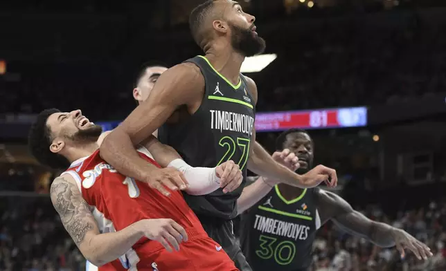 Minnesota Timberwolves center Rudy Gobert (27) and Memphis Grizzlies guard Scotty Pippen Jr. (1) collide in the second half of an NBA basketball game Thursday, April 10, 2025, in Memphis, Tenn. (AP Photo/Brandon Dill)
