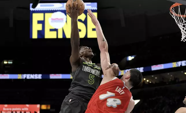Minnesota Timberwolves guard Anthony Edwards (5) shoots against Memphis Grizzlies center Zach Edey (14) in the first half of an NBA basketball game Thursday, April 10, 2025, in Memphis, Tenn. (AP Photo/Brandon Dill)