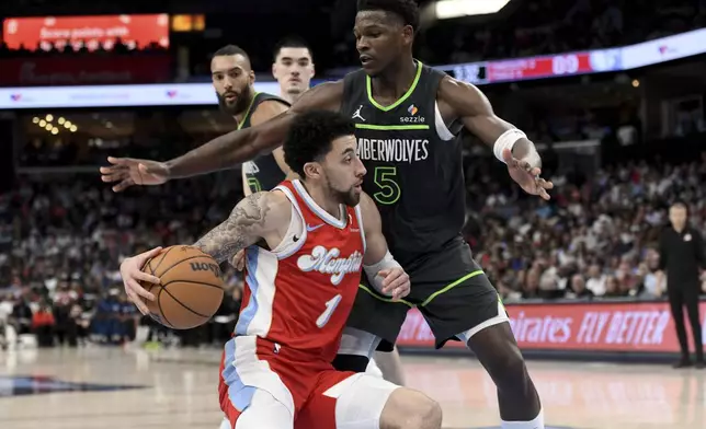 Memphis Grizzlies guard Scotty Pippen Jr. (1) handles the ball against Minnesota Timberwolves guard Anthony Edwards (5) in the second half of an NBA basketball game Thursday, April 10, 2025, in Memphis, Tenn. (AP Photo/Brandon Dill)