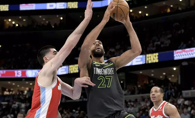 Minnesota Timberwolves center Rudy Gobert (27) shots against Memphis Grizzlies center Zach Edey in the first half of an NBA basketball game Thursday, April 10, 2025, in Memphis, Tenn. (AP Photo/Brandon Dill)