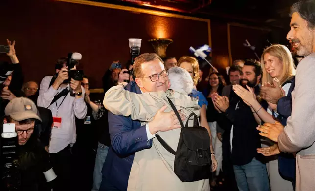 Bloc Québécois Leader Yves-Francois Blanchet, center left, greets supporters on election night, in Montreal, Tuesday, April 29, 2025. (Christopher Katsarov/The Canadian Press via AP)