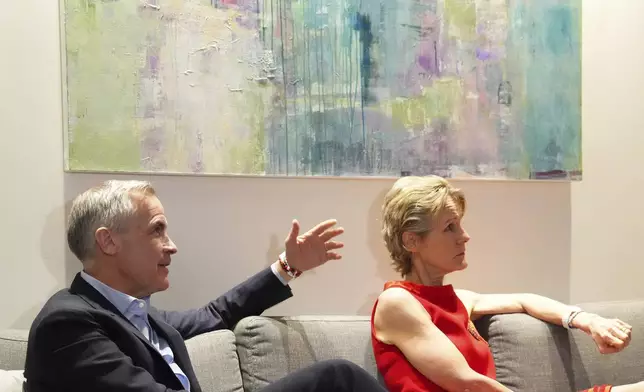 Canada's new Prime Minister and Liberal Leader Mark Carney and his wife Diana Fox Carney take in the results on election night in Ottawa, Ontario, Monday, April 28, 2025. (Sean Kilpatrick/The Canadian Press via AP)