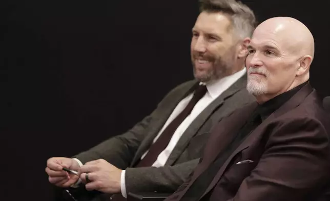 Washington Commanders general manager Adam Peters, left, and head coach Dan Quinn, right, listen to first-round draft pick offensive tackle Josh Conerly Jr. during an NFL football news conference in Ashburn, Va., Friday, April 25, 2025. (AP Photo/Luis M. Alvarez)