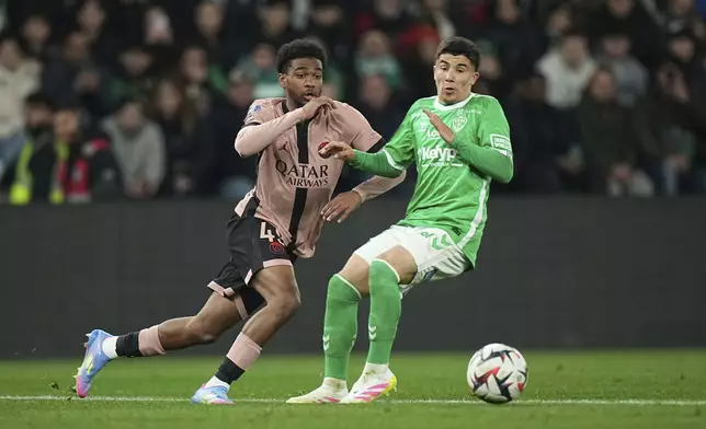 PSG's Ibrahim Mbaye, left, in action during the French League One soccer match between Saint-Etienne and Paris Saint Germain at the Geoffroy-Guichard stadium in Saint-Etienne, France, Saturday, March 29, 2025. (AP Photo/Laurent Cipriani)