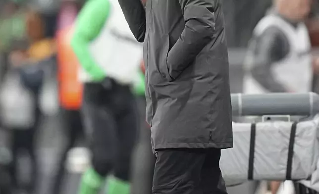 PSG's head coach Luis Enrique gestures during the French League One soccer match between Saint-Etienne and Paris Saint Germain at the Geoffroy-Guichard stadium in Saint-Etienne, France, Saturday, March 29, 2025. (AP Photo/Laurent Cipriani)