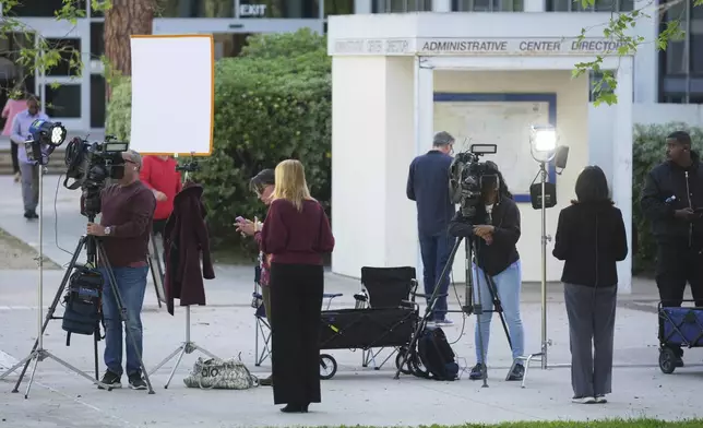 Media stage outside the Van Nuys West Courthouse before a hearing regarding the case of Erik and Lyle Menendez Friday, April 11, 2025, in Los Angeles. (AP Photo/Damian Dovarganes)