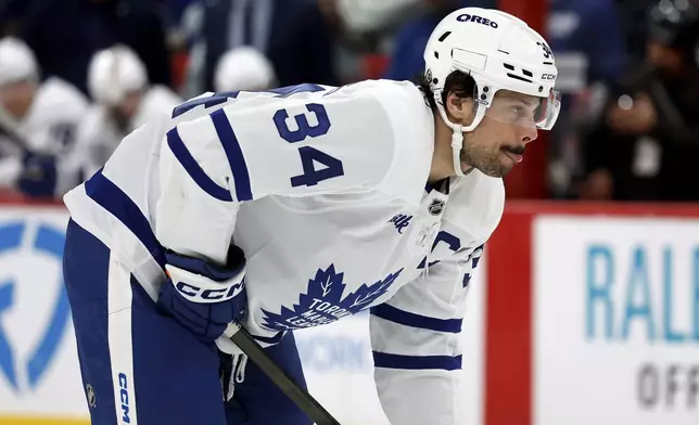 Toronto Maple Leafs' Auston Matthews (34) watches the puck against the Carolina Hurricanes during the first period of an NHL hockey game in Raleigh, N.C., Sunday, April 13, 2025. (AP Photo/Karl DeBlaker)