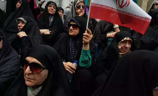 An Iranian protester waves her country's flag during an anti-Israeli demonstration at the Felestin (Palestine) Sq. in Tehran, Iran, Wednesday, April 9, 2025. (AP Photo/Vahid Salemi)